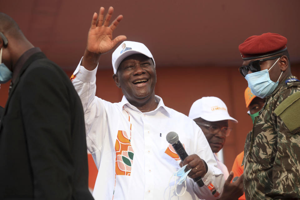 Ivory Coast President Alassane Ouattara cheers during his last rally in Abidjan, Ivory Coast, Thursday Oct. 29, 2020. Ouattara, who first came to power after the 2010 disputed election whose aftermath left more than 3,000 people dead, is now seeking a third term in office. Opposition candidate Henri Konan Bedie called for a boycott of the Oct. 31 election, complaining that the country's electoral commission is made up entirely of officials from the ruling party.(AP Photo/Diomande Ble Blonde)