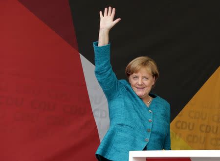 German Chancellor Angela Merkel, a top candidate of the Christian Democratic Union Party (CDU), greets audience during the election rally ahead of the upcoming federal election in Annaberg-Buchholz, Germany August 17, 2017. REUTERS/Matthias Schumann