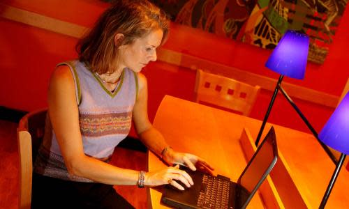 A woman working on a laptop at a Starbucks