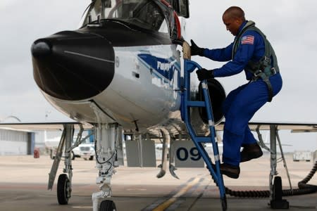 NASA commercial crew astronauts Victor Glover climbs into a T38 aircraft for a training flight with fellow astronaut Michael Hopkins in Houston, Texas