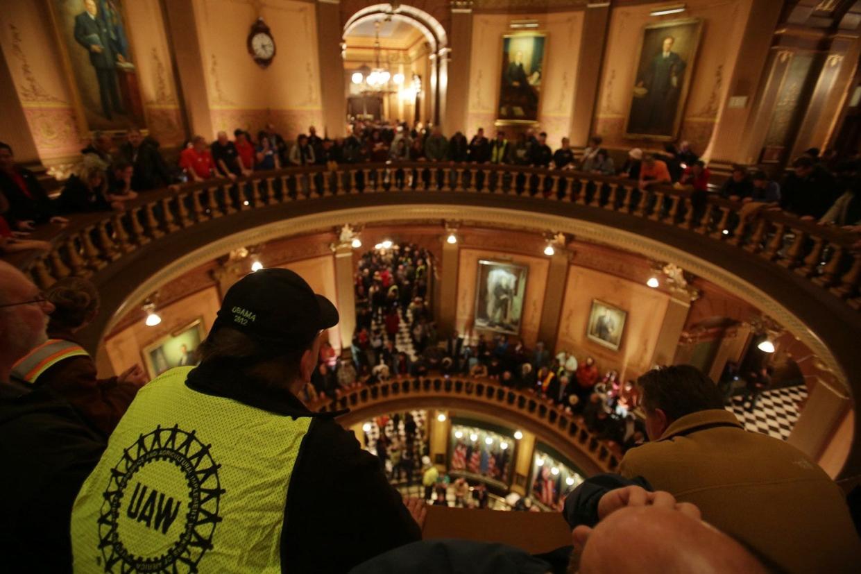 After people are finally allowed inside the Michigan State Capitol they erupt in chant as the Michigan House votes on controversial right-to-work legislation after House Democrats walked off the chamber floor to protest the Capitol in Lansing not being opened to the public on Thursday Dec. 6, 2012. Over a decade later, Democratic lawmakers repealed Michigan's right-to-work law after winning majorities in the state Legislature.