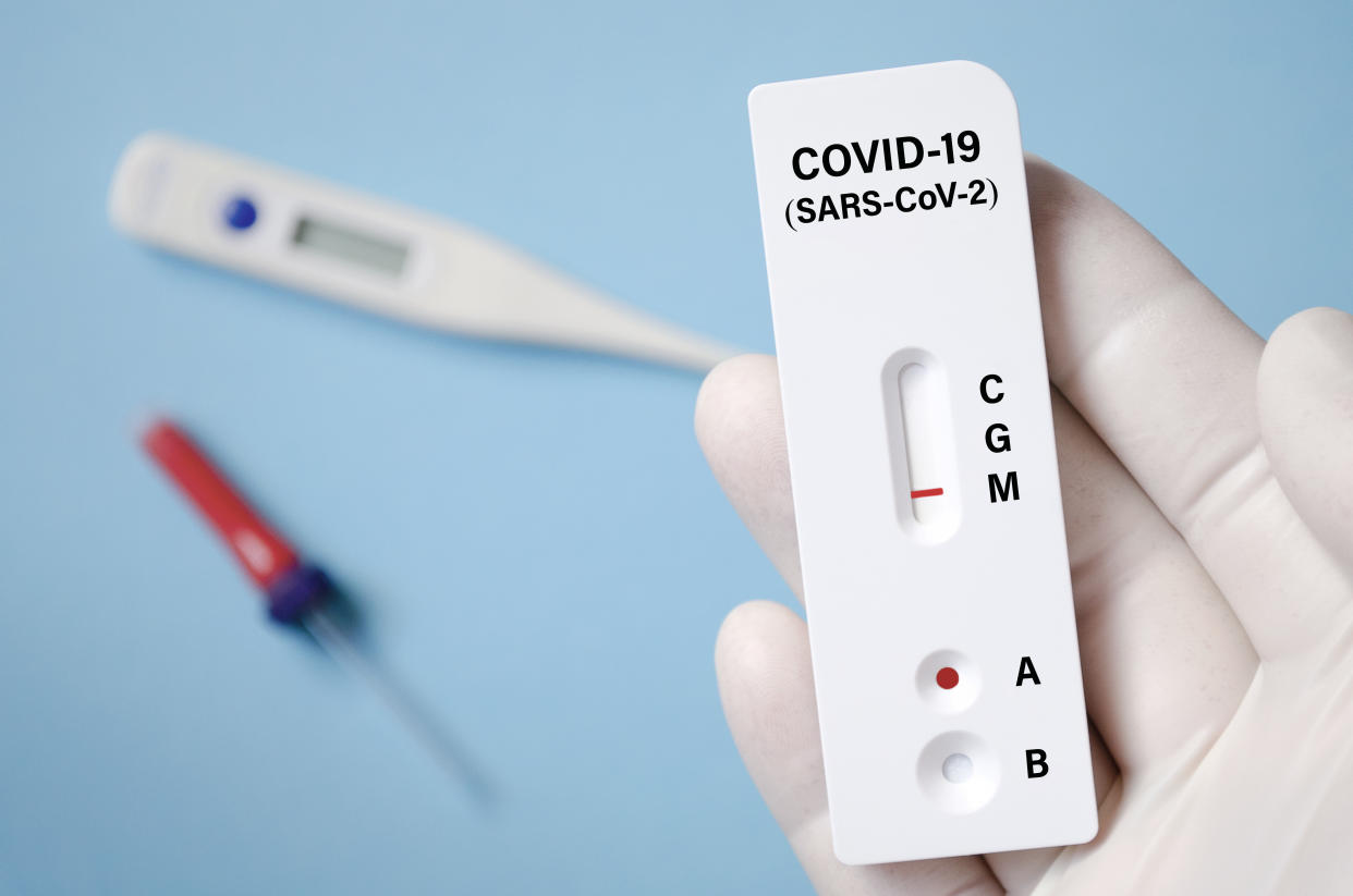 Positive test result by using rapid test for COVID-19, quick fast antibody point of care testing.