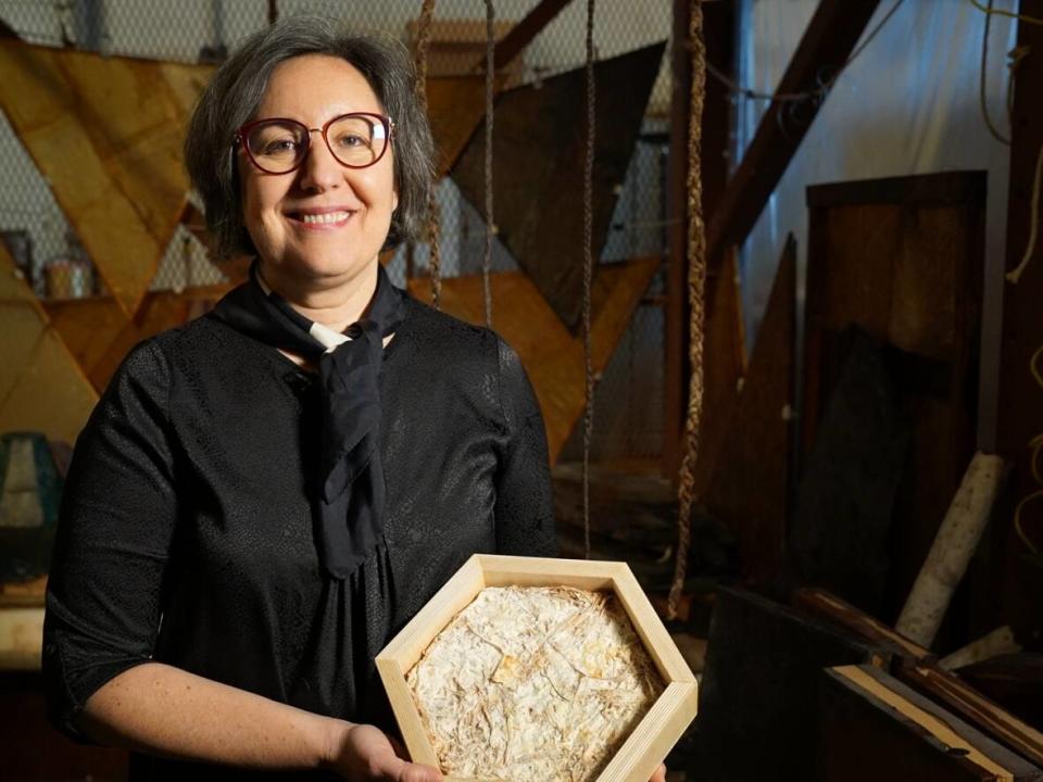 Architecture professor Mercedes Garcia-Holguera holds a brick made from mycelium and flax, an organic building material her team is testing for potential use building homes in isolated Manitoba communities. (Jaison Empson/CBC - image credit)