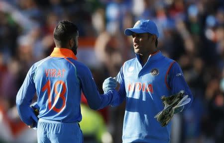 Britain Cricket - India v Pakistan - 2017 ICC Champions Trophy Group B - Edgbaston - June 4, 2017 India’s Virat Kohli and MS Dhoni celebrate at the end of the match Action Images via Reuters / Andrew Boyers Livepic