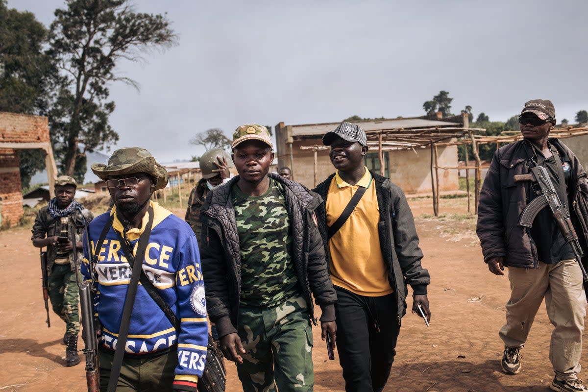 Commanders of the militia group Codeco walk through Linga village in Ituri province of Congo (Getty)