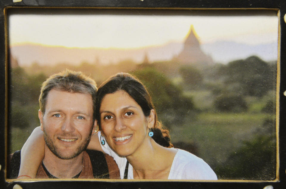 A photo of Richard Ratcliffe and his wife Nazanin Zaghari-Ratcliffe, who has been jailed in Iran, on display at their home in north London on Sunday Dec. 17, 2017.  British media on Thursday Dec. 21, 2017 were reporting that British-Iranian woman Nazanin Zaghari-Ratcliffe detained for months in Iran for allegedly plotting to overthrow the government could be released "within a couple of weeks." (John Stillwell/PA  via AP)