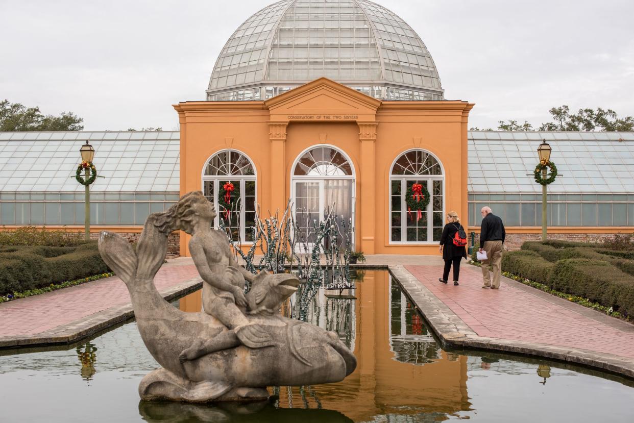 New Orleans, LA/USA-Jan. 26, 2018: A A beautiful couple wanders the Pavilion of Two Sisters in the historic City Park, which was founded in 1854.