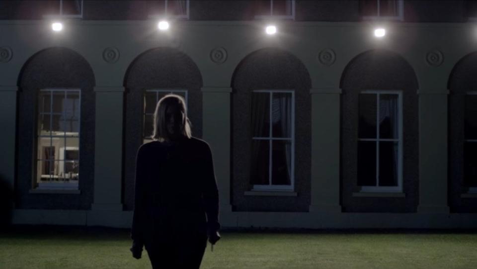 A woman attempts to search for someone on her lawn at night in "Don't Knock Twice"