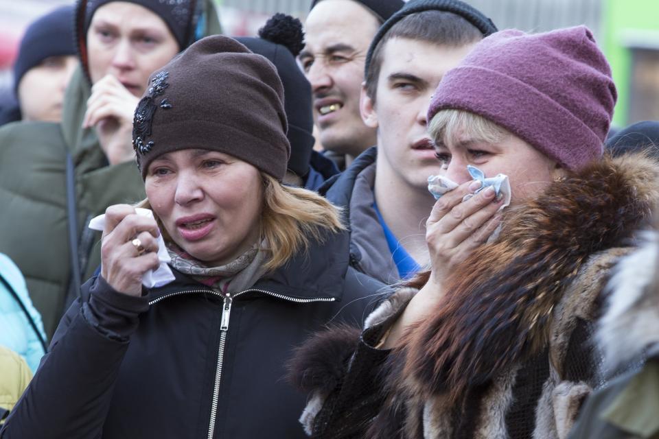 People lay flowers for the victims