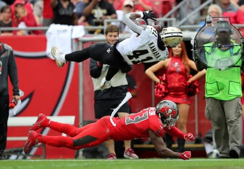 New Orleans Saints running back Alvin Kamara (41) leaps over Tampa Bay Buccaneers outside linebacker Adarius Taylor (53) during the second half at Raymond James Stadium - Credit: Kevin Jairaj/USA TODAY