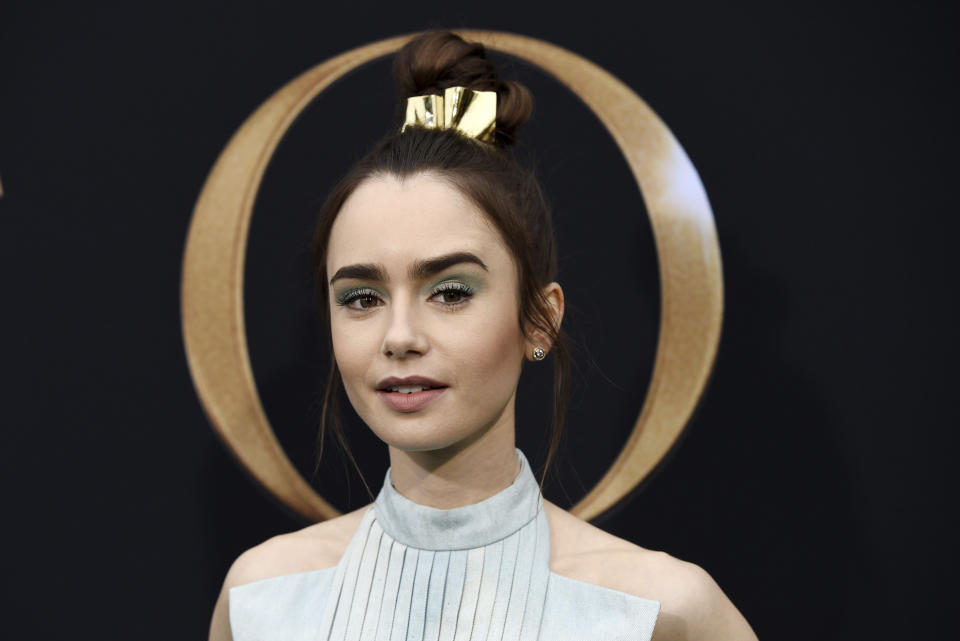 Lily Collins, a cast member in "Tolkien," poses at the premiere of the film in Los Angeles on May 8, 2019. The film explores the formative years of J.R.R. Tolkien, author of the classic fantasy novels "The Hobbit" and "The Lord of the Rings." (Photo by Chris Pizzello/Invision/AP)