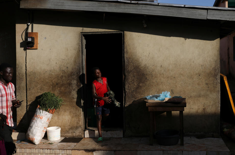 A boy walks out of his home in Mampong, a small town in the Ashanti region, Ghana. (Photo: Siphiwe Sibeko/Reuters)