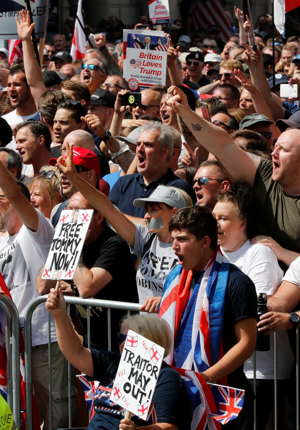 <p>Demonstrators hold placards supporting English Defense League founder Tommy Robinson and President Trump in London, July 14, 2018. (Photo: Yves Herman/Reuters) </p>