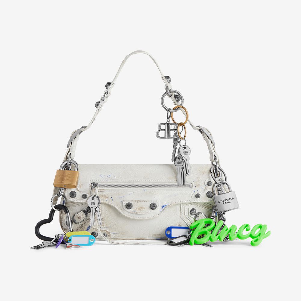 <p><a href="https://go.redirectingat.com?id=74968X1596630&url=https%3A%2F%2Fwww.balenciaga.com%2Fen-us%2Fle-cagole-small-sling-bag-used-effect-with-charms--white-813477683.html&sref=https%3A%2F%2Fwww.elle.com%2Ffashion%2Fshopping%2Fg60488199%2Fbag-charms-trend%2F" rel="nofollow noopener" target="_blank" data-ylk="slk:Shop Now;elm:context_link;itc:0;sec:content-canvas" class="link rapid-noclick-resp">Shop Now</a></p><p>Le Cagole Small Sling Bag With Charms</p><p>balenciaga.com</p><p>$5690.00</p>