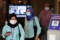 Employees wearing face masks to help curb the spread of the coronavirus leave their office in Kuala Lumpur, Malaysia, Monday, Oct. 26, 2020. Senior Minister Ismail Sabri Yaakob announce conditional movement control order (MCO) in Kuala Lumpur, Selangor and Putrajaya will be extended for another two weeks until Nov 9. (AP Photo/Vincent Thian)