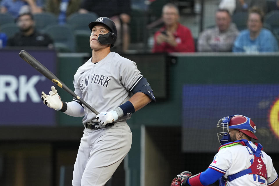 New York Yankees' Aaron Judge reacts to striking out in the first inning of a baseball game as Texas Rangers' Sandy Leon prepares to throw the ball back to the mound Thursday, April 27, 2023, in Arlington, Texas. (AP Photo/Tony Gutierrez)