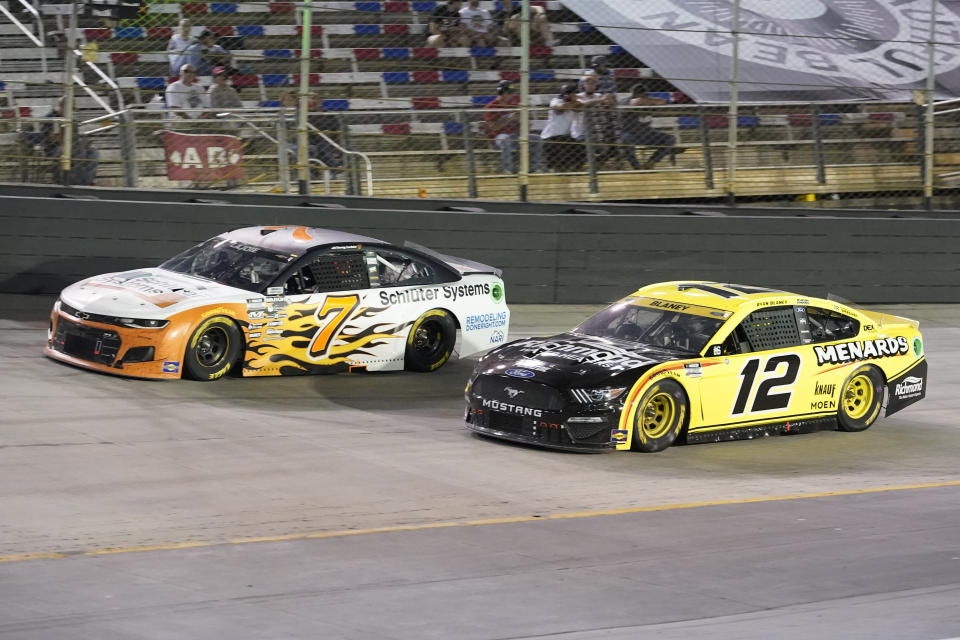 Corey LaJoie (7) and Ryan Blaney (12) come through a turn during a NASCAR Cup Series auto race at Bristol Motor Speedway Saturday, Sept. 18, 2021, in Bristol, Tenn. (AP Photo/Mark Humphrey)