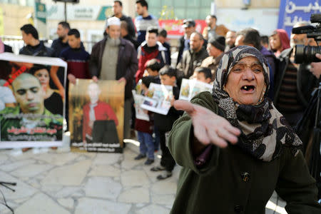 FILE PHOTO: A Palestinian woman reacts during a protest following the sentencing of Israeli soldier Elor Azaria, in the West Bank City of Hebron February 21, 2017. REUTERS/Ammar Awad/File Photo