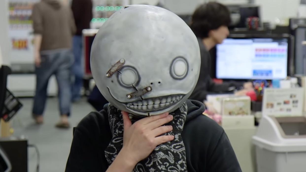  NieR creator Yoko Taro in his trademark Emil mask from the games. 