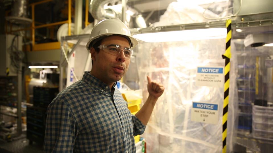 Aaron Manalaysay, the physics coordinator of Lawrence Berkeley National Lab's experiment, explains how the underground detector will interact with dark matter in the Sanford Underground Research Facility in Lead, S.D., on Dec. 8, 2019. Scientists have begun a new search for mysterious dark matter in a former gold mine a mile underground. Dark matter makes up the vast majority of the mass of the universe but scientists don't know what it is. (AP Photo/Stephen Groves)