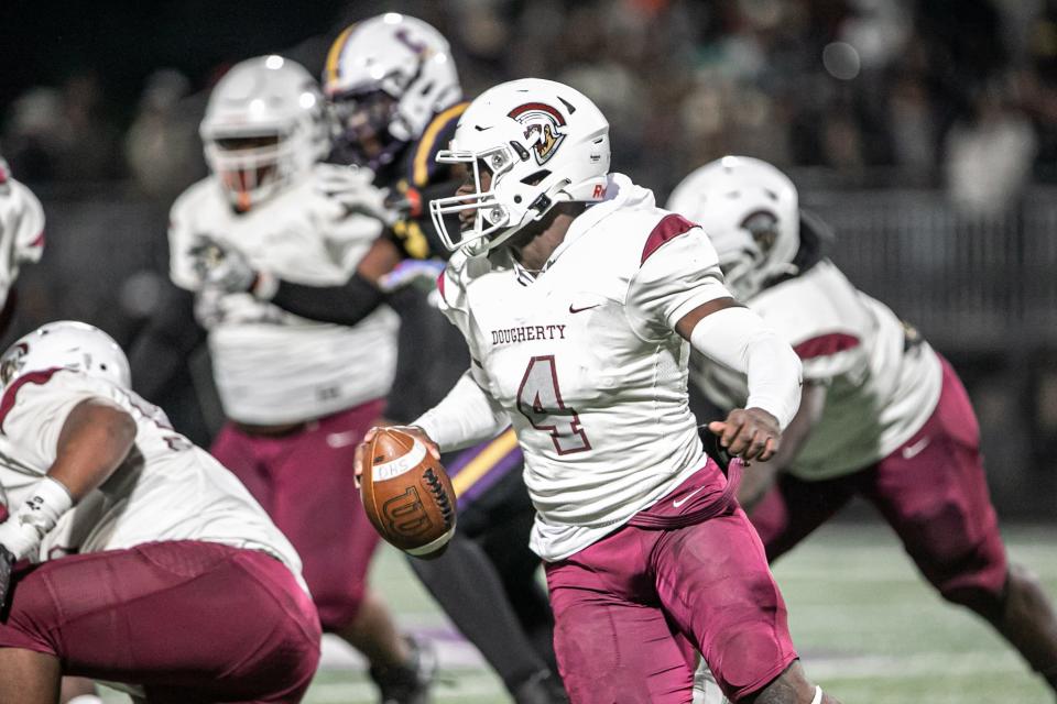 Dougherty’s quarterback Kameron Davis scrambles in the pocket to avoid a sack from the Cavaliers’ defense.