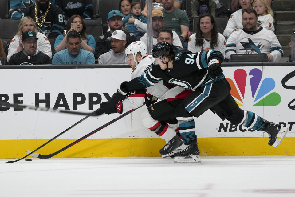 San Jose Sharks left wing Alexander Barabanov (94) reaches for the puck next to Ottawa Senators defenseman Erik Brannstrom during the second period of an NHL hockey game Saturday, March 9, 2024, in San Jose, Calif. (AP Photo/Jeff Chiu)