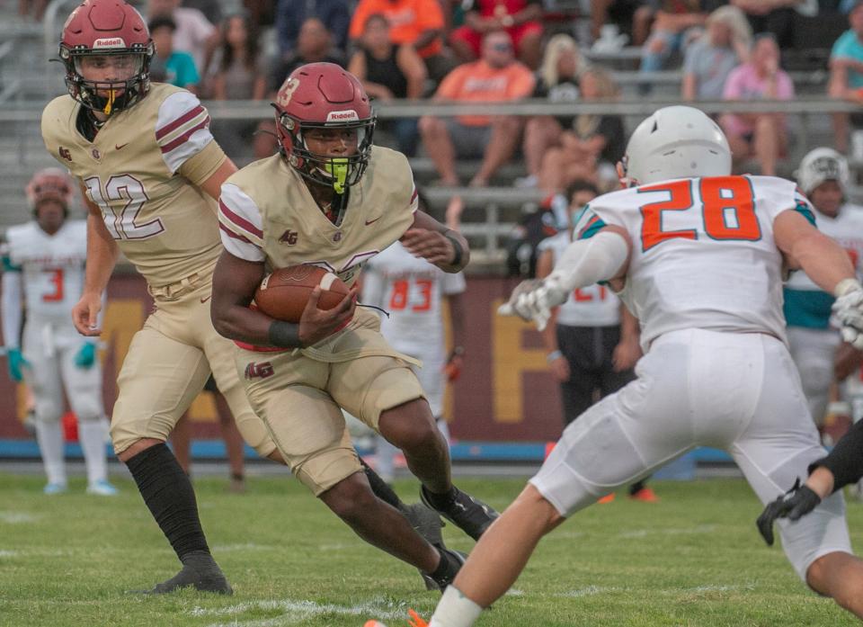 Lake Gibson High School's Fentrell Graham (23) rushes the ball against Plant City High School during the first quarter at Lake Gibson in Lakeland Friday night. August 19, 2022.