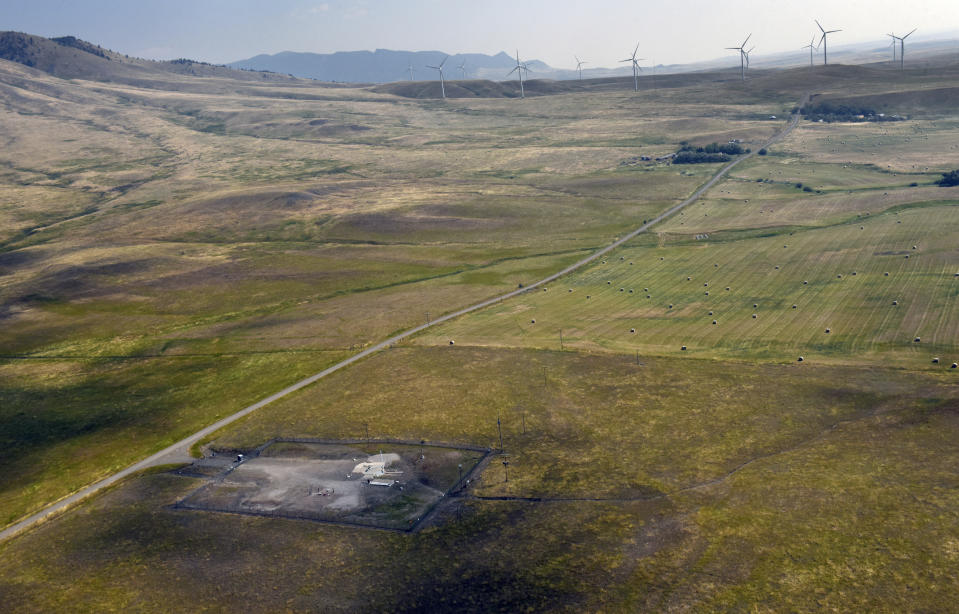 In this image provided by the U.S. Air Force, wind turbines spin near the Malmstrom Air Force Base missile launch site Alpha-03 in Geyser, Mont., in August 2023. As the nation's energy needs have increased, turbines have grown in size and number, and are being placed closer to the underground silos where Minuteman III intercontinental ballistic missiles are kept ready to fire. The Air Force is concerned that the turbines are making it dangerous for their helicopter crews to fly out to the sites, often flying low and fast, when responding to an alarm at one of the silos. The service is seeking a two nautical mile buffer zone around the sites. (John Turner/U.S. Air Force via AP)