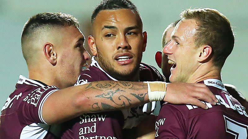 Addin Fonua-Blake is pictured in the centre here with Manly teammates.