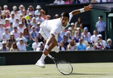 Novak Djokovic of Serbia hits a shot during his match against Richard Gasquet of France at the Wimbledon Tennis Championships in London, July 10, 2015. REUTERS/Suzanne Plunkett
