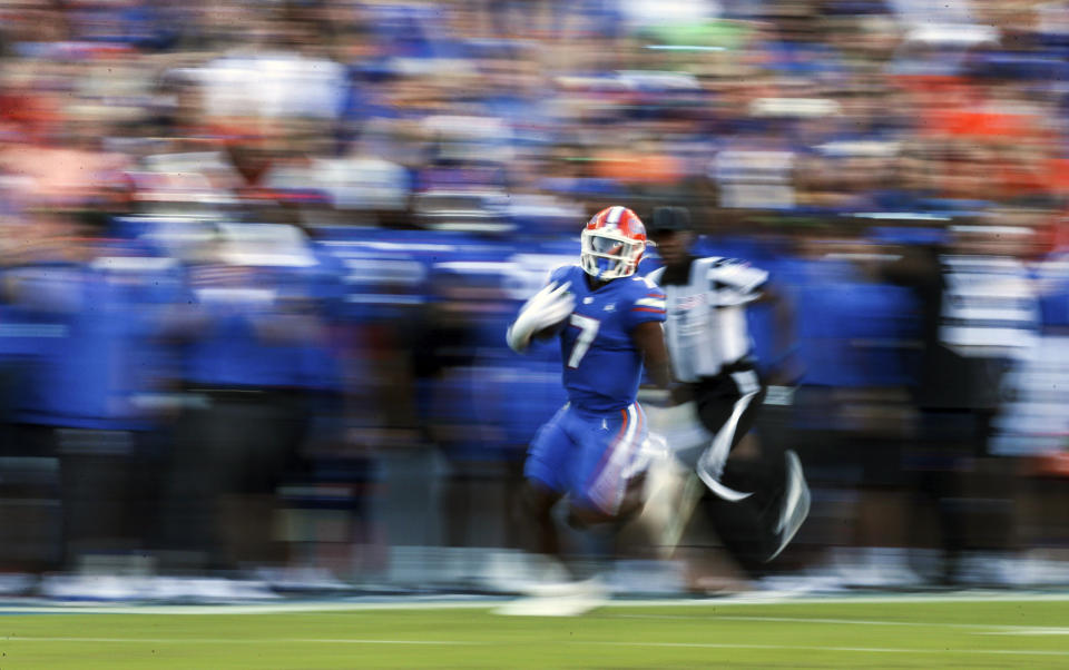 Florida running back Trevor Etienne (7) scores an 85-yard touchdown against South Carolina during the first half of an NCAA college football game, Saturday, Nov. 12, 2022, in Gainesville, Fla. (AP Photo/Matt Stamey)