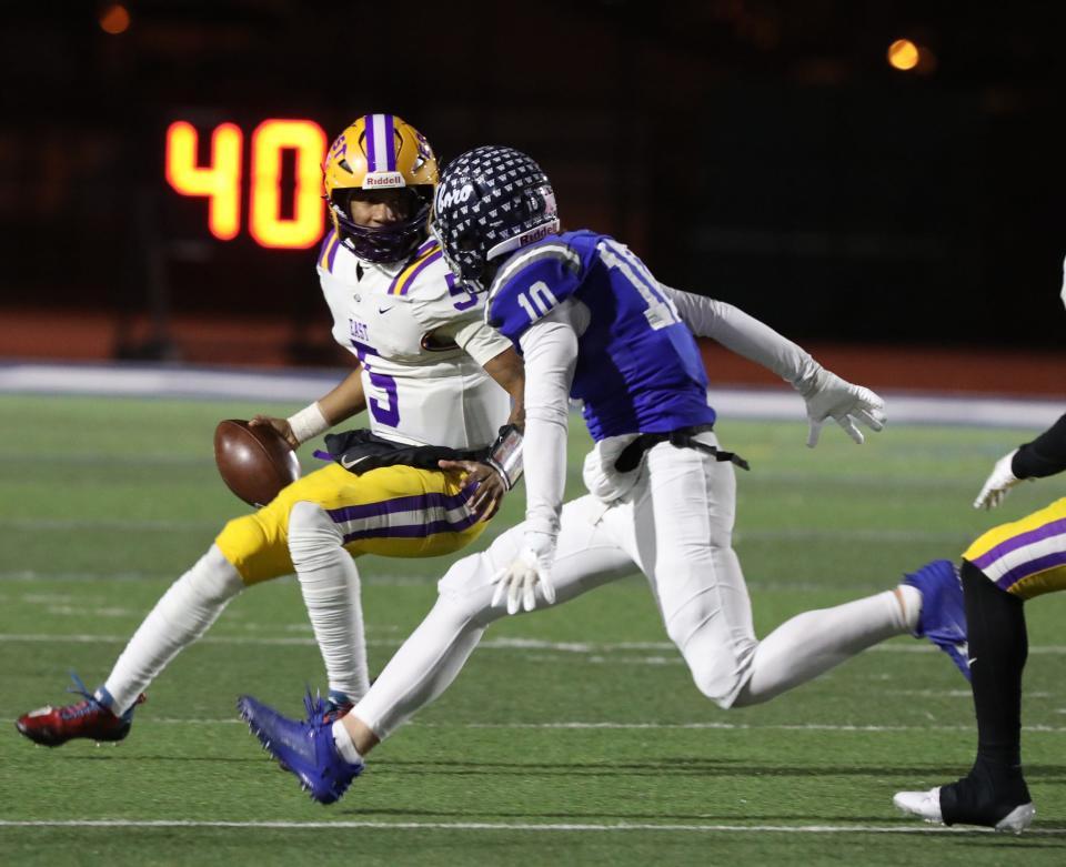 East/WOIS Quarterback Zymier Jackson avoids Whitesboro Carmen Centro and gains approximately eight yards on the play running the ball.