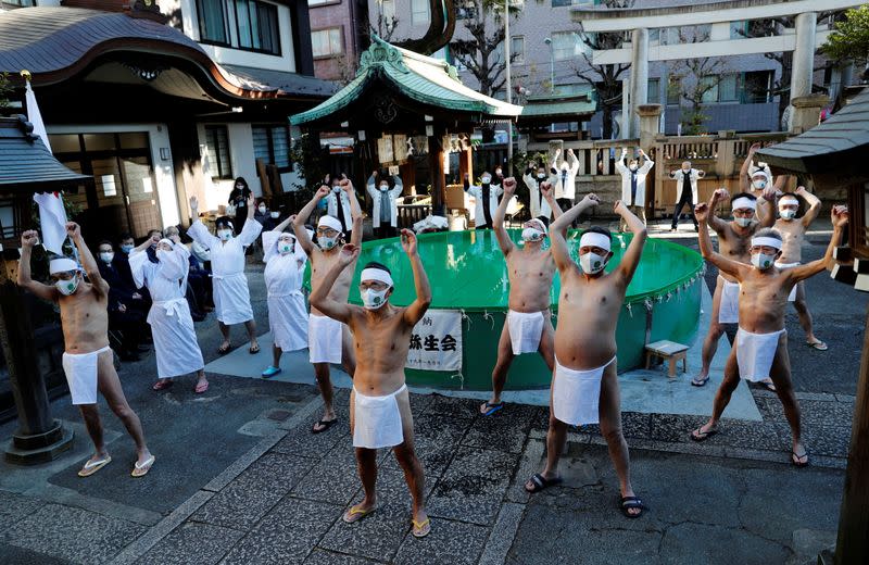 Participants wearing protective face masks amid the coronavirus disease (COVID-19) outbreak, take an ice-cold bath at a ceremony in Tokyo