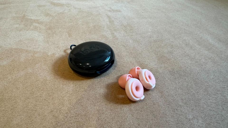 Loop Switch earbuds on a pink surface
