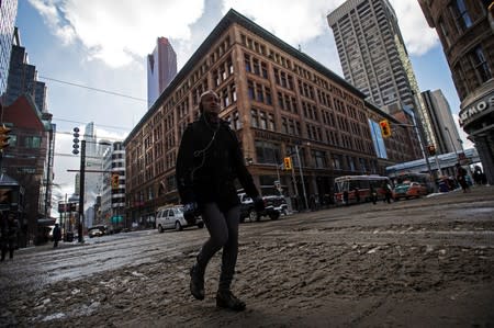 FILE PHOTO: A man walks in front of the Hudson's Bay Company (HBC) flagship department store in Toronto