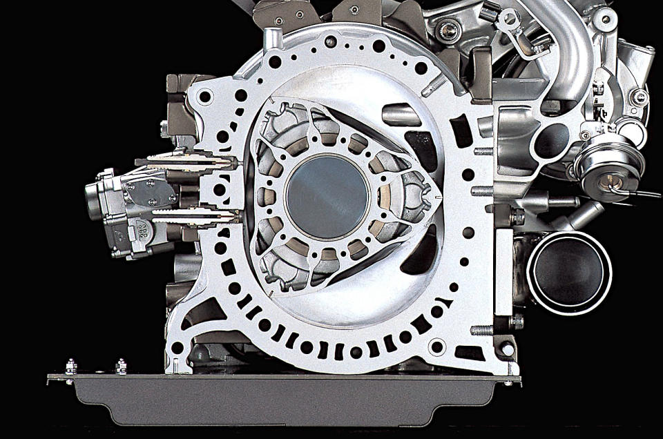 <p>As the Wankel engine is understood today, it consists of a more or less triangular rotor (or rotors) spinning eccentrically in a chamber which is roughly the shape of the number eight. For every spin of the rotor, the usual process of taking in a fuel/air mixture, compressing it, igniting it and expelling the resultant exhaust gases happens three times. The crankshaft turns three times during this process, since it’s geared to the rotor at a ratio of 3:1.</p><p>Rotaries have a reputation for achieving high revs, but this is slightly misleading. When the engine is said to rev at 9000rpm, the crankshaft turns at that speed, and there are as many combustion cycles as there would be in a piston engine operating at that rate, but the rotors themselves are turning at only <strong>3000rpm.</strong></p>