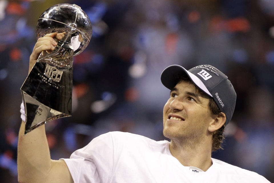 FILE - In this Feb. 5, 2012, file photo, New York Giants quarterback Eli Manning celebrates with the Vince Lombardi Trophy after the Giants' 21-17 win over the New England Patriots in the NFL Super Bowl XLVI football game in Indianapolis. Eli Manning's long and distinguished reign as the Giants' starting quarterback is seemingly over. Let the Daniel Jones era begin. Coach Pat Shurmur announced Tuesday, Sept. 17, 2019, that the No. 6 overall pick in the NFL draft is replacing two-time Super Bowl MVP as the Giants' quarterback, beginning Sunday at Tampa Bay.(AP Photo/Chris O'Meara)