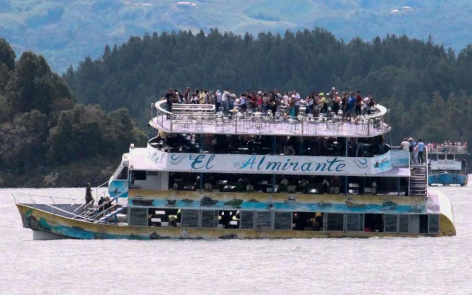 Passengers onboard the tourist boat as it sinks - Credit: Juan Quiroz/AFP