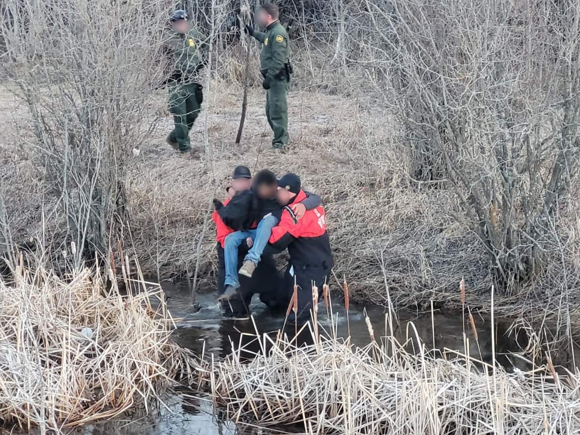 U.S. Border Patrol Agents and emergency agencies rescued nine people from a wetland west of Warroad, Minn. on Tuesday. All crossed the border from Canada illegally and were suffering from exposure to the elements. Two continue to receive medical care.  (U.S. Border Patrol - image credit)