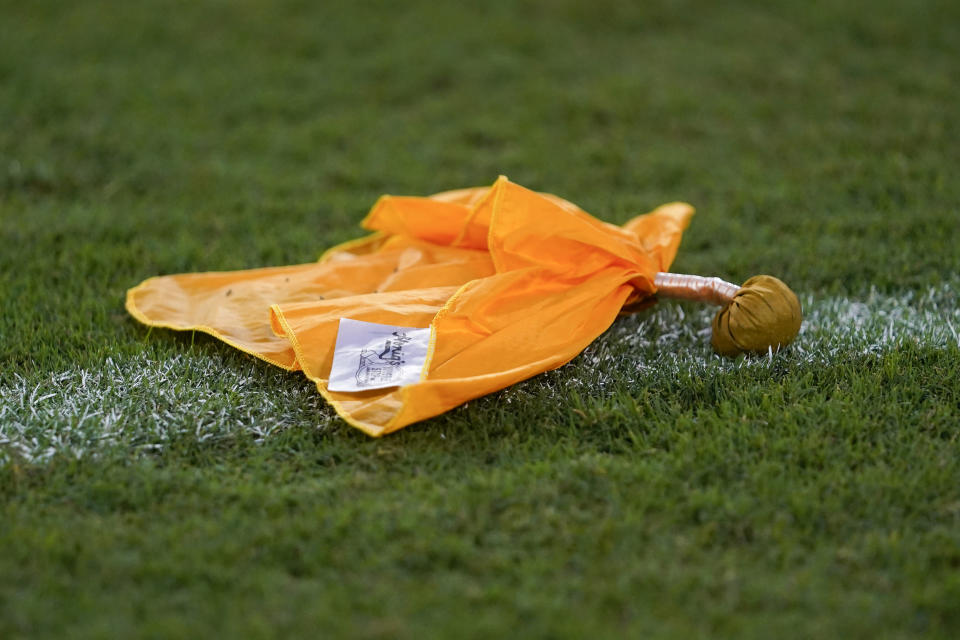 A penalty flag rests on the field. (AP Photo/Julio Cortez)