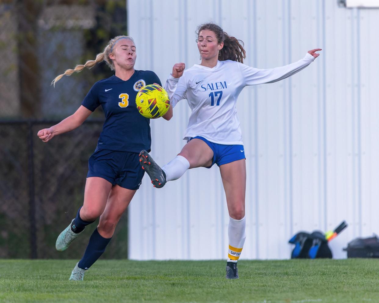 Hartland's Paige Sundman (3) rushes in to break up a kick by Salem's Elaine Rama Tuesday, April 23, 2024.