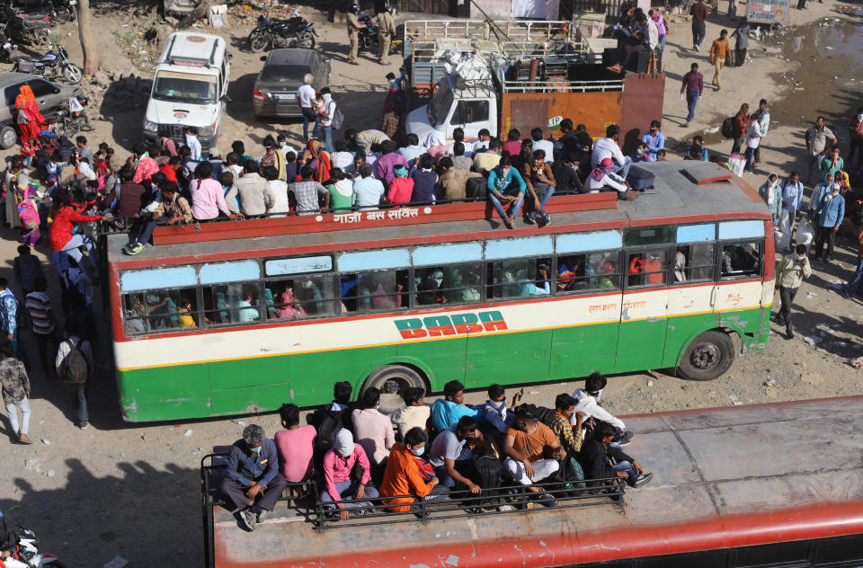 NEW DELHI, INDIA - MARCH 28: Migrant workers are seen on a bus to go their native villages during nationwide lockdown as a precaution against coronavirus (COVID-19) pandemic, in New Delhi, India on March 28, 2020. (Photo by Amarjeet Kumar Singh/Anadolu Agency via Getty Images)