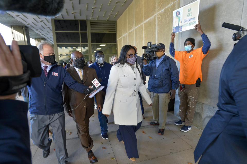 Rochester Mayor Lovely Warren, center, walks out of city court after her arraignment in Rochester, N.Y., Monday, Oct. 5, 2020. Warren, who has faced calls to resign over her city's handling of the suffocation death of Daniel Prude at the hands of police, pleaded not guilty Monday to campaign finance charges dating to her 2017 reelection campaign. (AP Photo/Adrian Kraus)