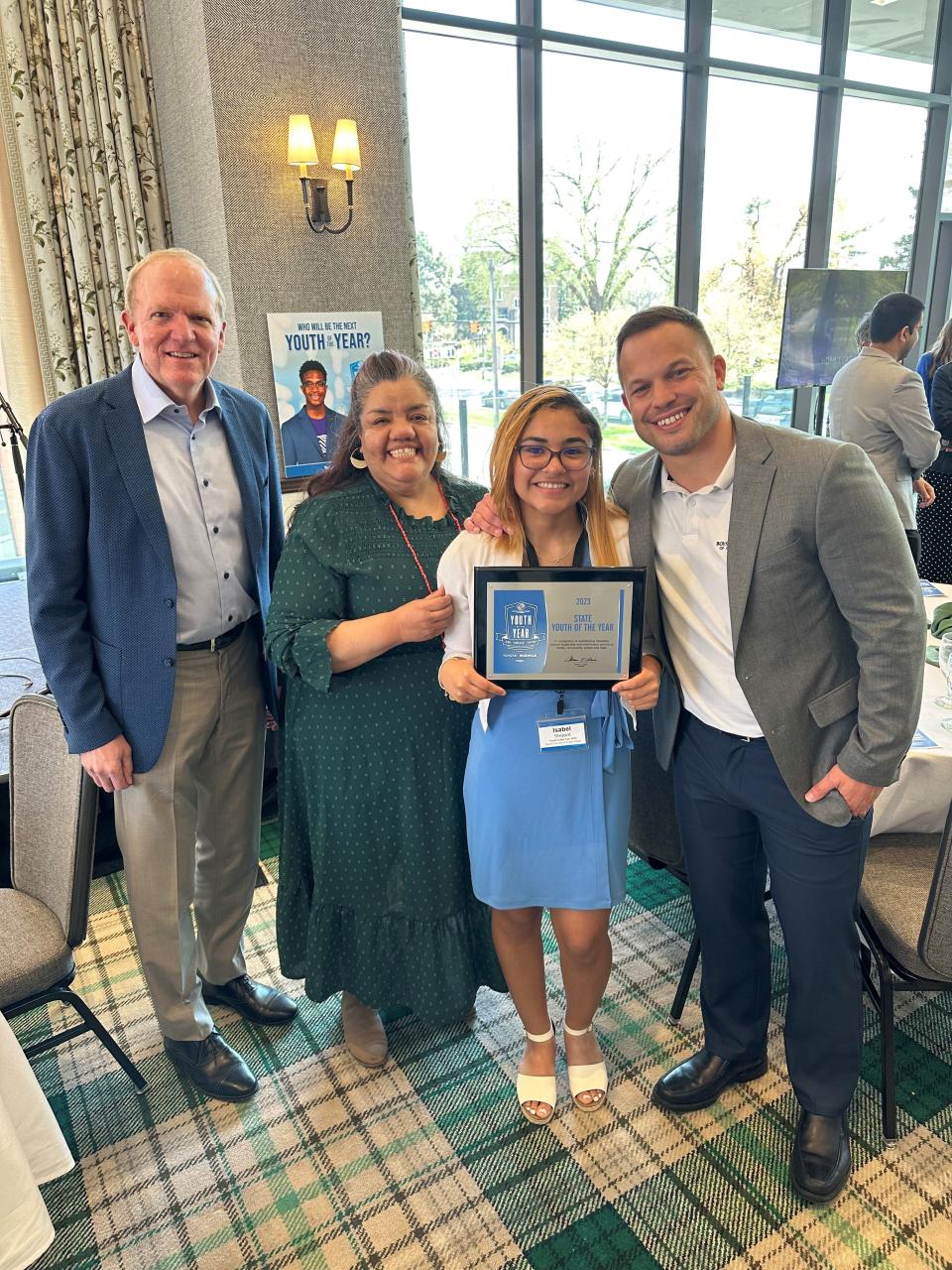 Isabel Shepard (center right) stands with Boys & Girls Club of Greater Holland staff (from left) Craig Spoelhof, Mary Carrizales and Justin Caserta.