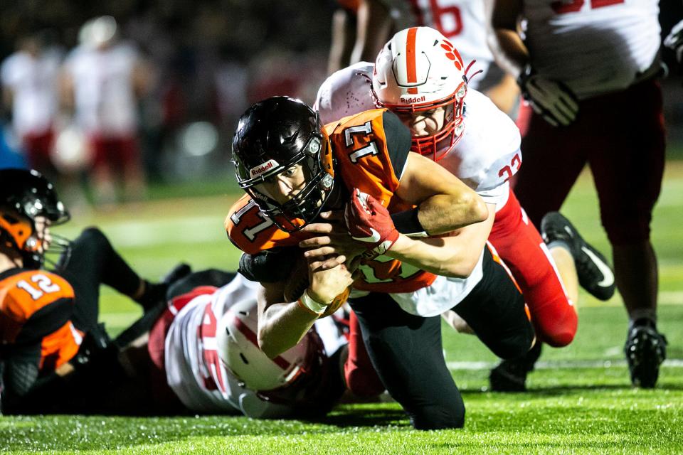 Cedar Rapids Prairie quarterback Brandon Vlcko (17) gets tackled by Cedar Falls defensive end Drew Campbell in 2021. Campbell will be looking to guide the Tigers back to the UNI-Dome after missing out a season ago.