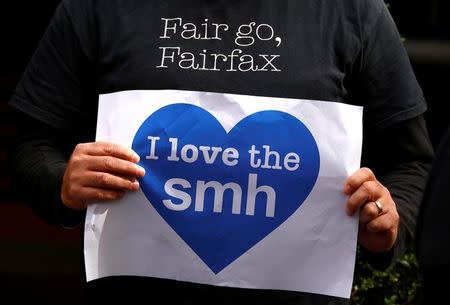 A Fairfax journalist holds a placard and wears a shirt displaying a slogan during a protest regarding the announcement of further staff cuts to the Sydney Morning Herald (SMH) and Melbourne Age newspapers in central Sydney, Australia, May 4, 2017. REUTERS/David Gray