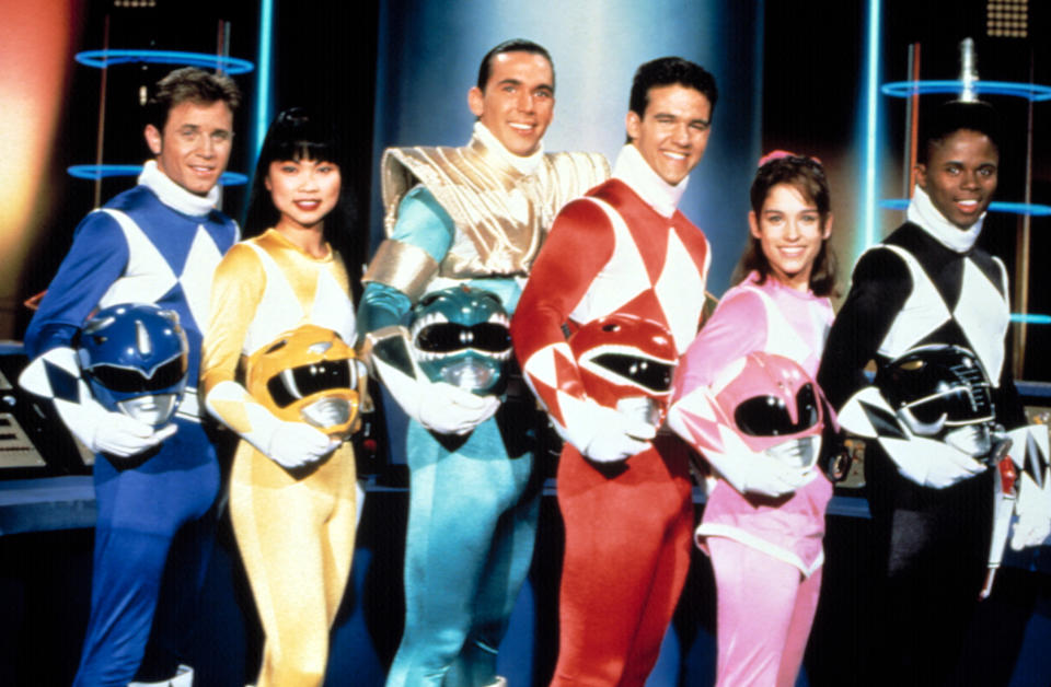 The power rangers pose with their helmets off