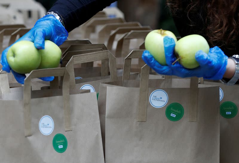 A worker from Annabel's private members club prepares meal packs for NHS staff at their premises in London