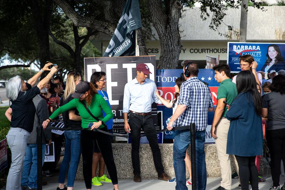 Texas gubernatorial candidate Beto O'Rourke takes photos with people outside of the Nueces County Courthouse on Monday, Oct. 31, 2022, in Corpus Christi, Texas.