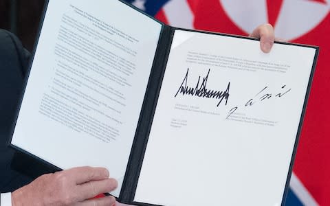 A close-up shot of the document signed by the leaders - Credit: SAUL LOEB /AFP